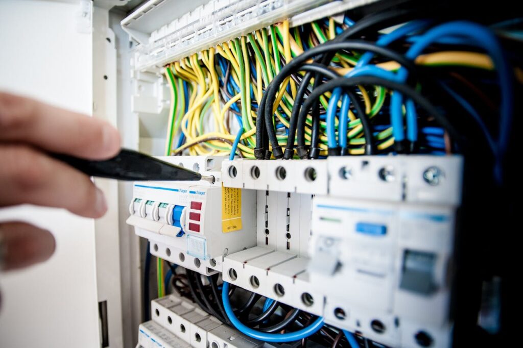 electrician-fixing-an-opened-switchboard-257736 Electrician Fixing an Opened Switchboard